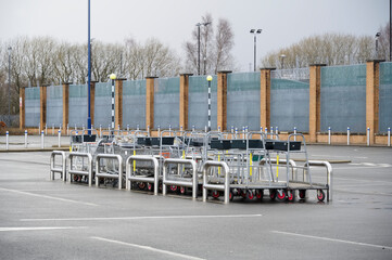 Shopping trolley group at closed shop car park empty due to covid-19