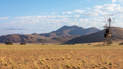 Antenna in the middle of nowhere with mountains in the back near Aus, Namibia.