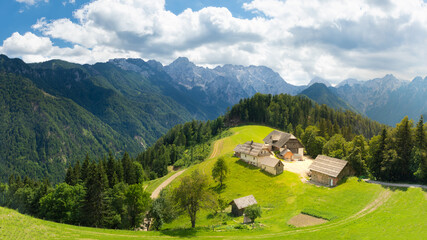 Amazing landscape with snowy mountains in Slovenia. Logarska Dolina and alpine rural farm with houses from the Solcava panoramic road, Logar valley, Slovenia, Europe. © Gunter