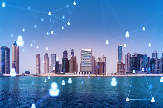 Skyscrapers of Dubai business downtown. International hub of trading and financial services. Social network icons hologram, concept of people connection. Double exposure. Dubai Canal waterfront. - Powered by Adobe