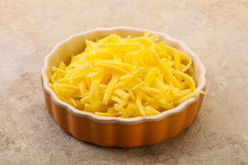Shredded yellow cheese in the bowl