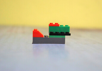 Plastic building blocks on wall background