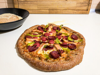 Homemade whole wheat pizza with pizza dough on semolina on the back