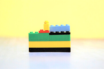 Plastic building blocks on wall background