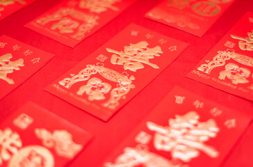 Chinese wedding gift red packets neatly arranged on red background