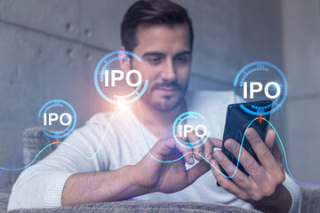 A man using smart phone. Double exposure. IPO symbol hologram. Initail primary offering concept.