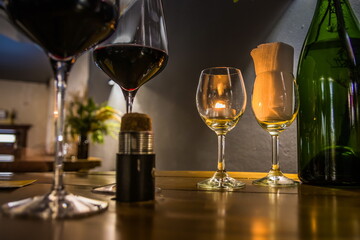 Glasses with red wine and candle in a restaurant