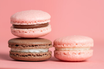 Pink and brown macaron on a pink background