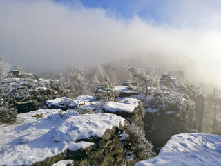 Top view of sandstone towers in clouds on sunny winter day - Tiske steny, Labske piskovce, Czech Republic