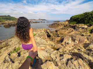 Help concept. Couple walking together in the sea. Concept of help. Man following woman holding hands