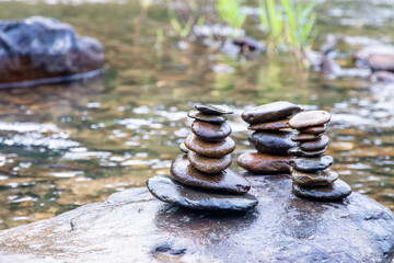 Balanced Zen rock stacks in a creek,View of a creek with stacked stones on a rock