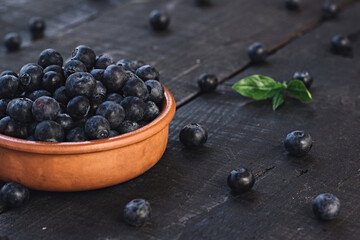 Fresh blueberry in wooden bowl. Concept of healthy and dieting eating