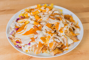 kebab with chips and sauce on plate