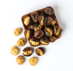 Roasted chestnut on wooden plate.