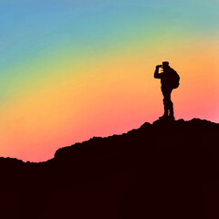 silhouette of photographer at the peak of mountain clicking pictures .