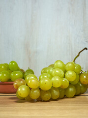 Green grapes on wooden table