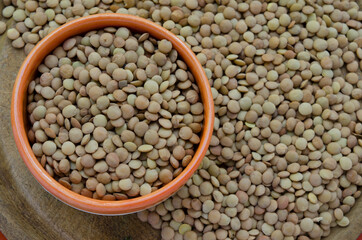 Obraz premium lentils background, on a wooden plate, organic legumes