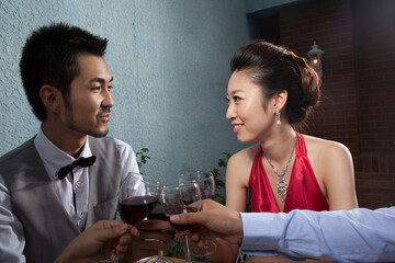 Four people sit together for dinner and chat