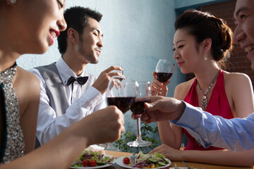 Four people sit together for dinner and chat
