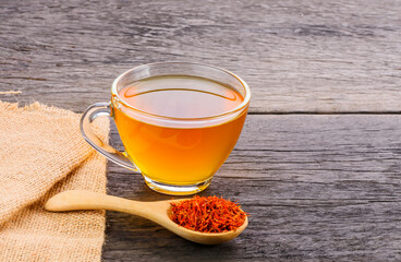 Safflower herbal tea on wooden table