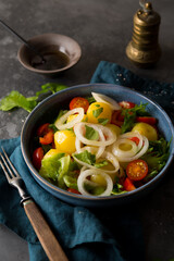 Boiled potatoes with onions and vegetables in a plate
