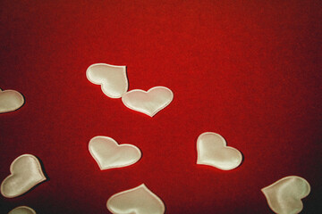 small white fabric hearts that are scatter