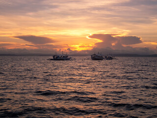 Naklejka na ściany i meble A stunning sunset sky over Malapascua Island in the Philippines