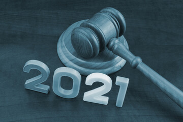 Wooden gavel and numbers 2021 on wooden table. Concept of new  rules.