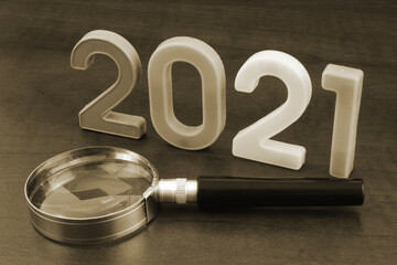 Review events in year 2021 concept. Magnifying glass and numbers 2021 close up.