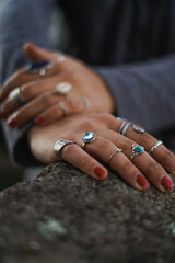 young woman hand posing with many rings