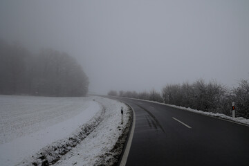 Dangerous stretch of road on a foggy winter morning