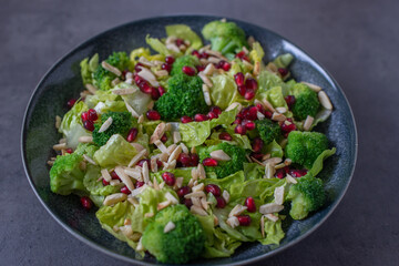 healthy tasty Broccoli salad with pomegranate on a table