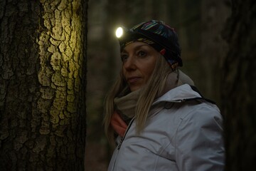 Beauty tourist woman with headlight in the forest at dark © Daniel Jędzura