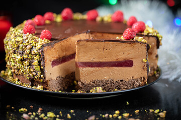 Chocolate mousse cake with raspberry jelly, raspberries and pistachios