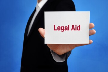 Legal Aid. Lawyer (man) holding a card in his hand. Text on the sign presents term. Blue background.