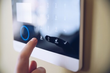Entering the code in the security system. Home security alarm.
