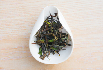 Fototapeta na wymiar Aged white tea leaves in a porcelain object, ready to be brewed Gong Fu Cha.