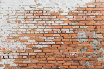 background of Old rough brick wall with stucco residues