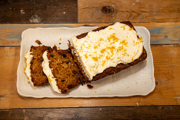 A delicious carrot cake on a wooden kitchen work top