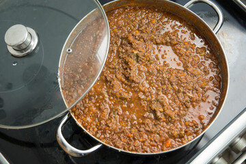 Top view of an homemade traditional Bolognese sauce (Ragù alla Bolognese) in a pot