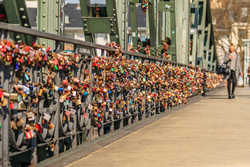 Many locks on the railing of the iron bridge in Frankfurt. Locks of love in different colors in the...