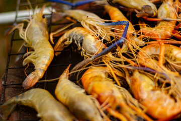 The grilled shrimp on the stove are about to be ready to eat.