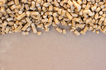 Fototapeta na wymiar wooden pellets background, pattern. Wood pellets on a blank brown background, free copy space. flat lay