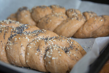 Traditional baked Challah bread, made of spelt flour, with topping of sesame and poppy seeds