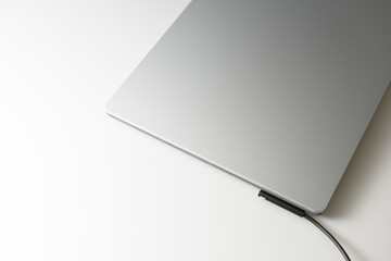 Close-up top view of laptop in platinum silver color on white background