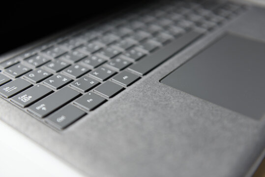 Close-up top view of laptop in platinum silver color on white background