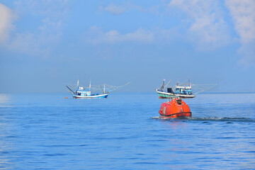Fototapeta premium Lifeboat or rescue boat Testing quality checking in the sea offshore oil and gas installations during inspection and maintenance.