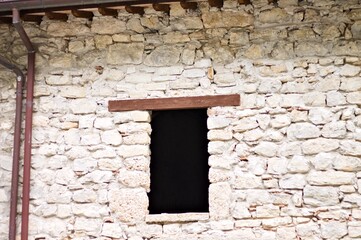 A window with a wooden lintel of an abandoned ruined building (Marche, Italy, Europe)