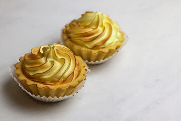 Tasty lemon tart with meringue on light background