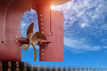 Shipyard Stern ship propeller, rudder and shafting port controller, surveyor, inspecting the final repairing of propeller on dry dock on blue sky background. © TawanSaklay